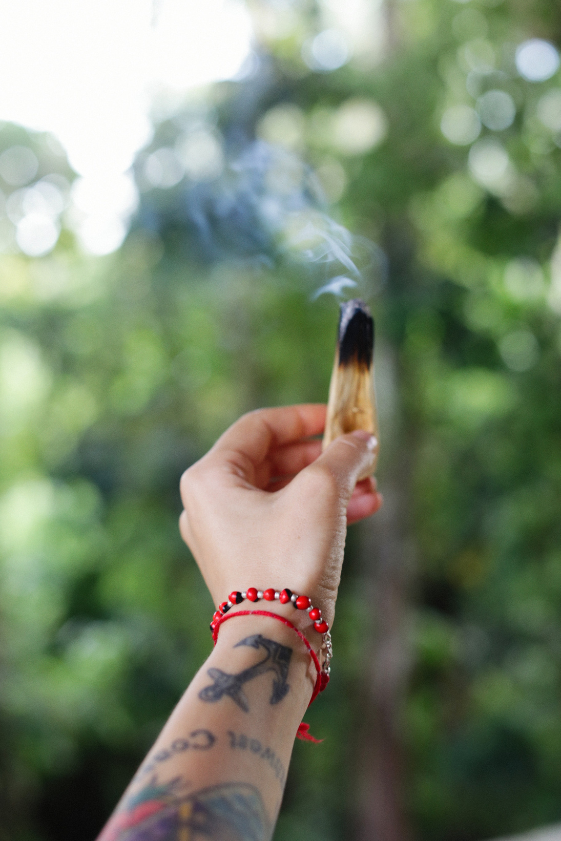 Person Holding a Burning Palo Santo